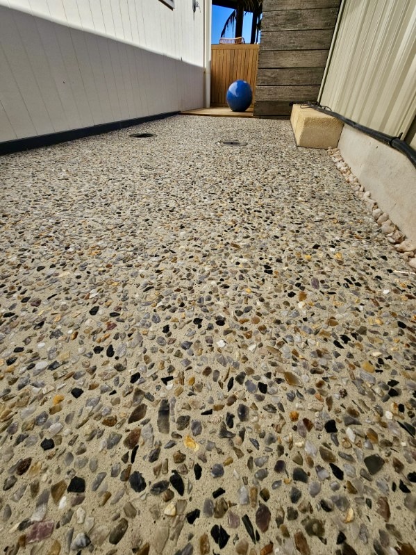 Exposed aggregate driveway in front of a modern home
